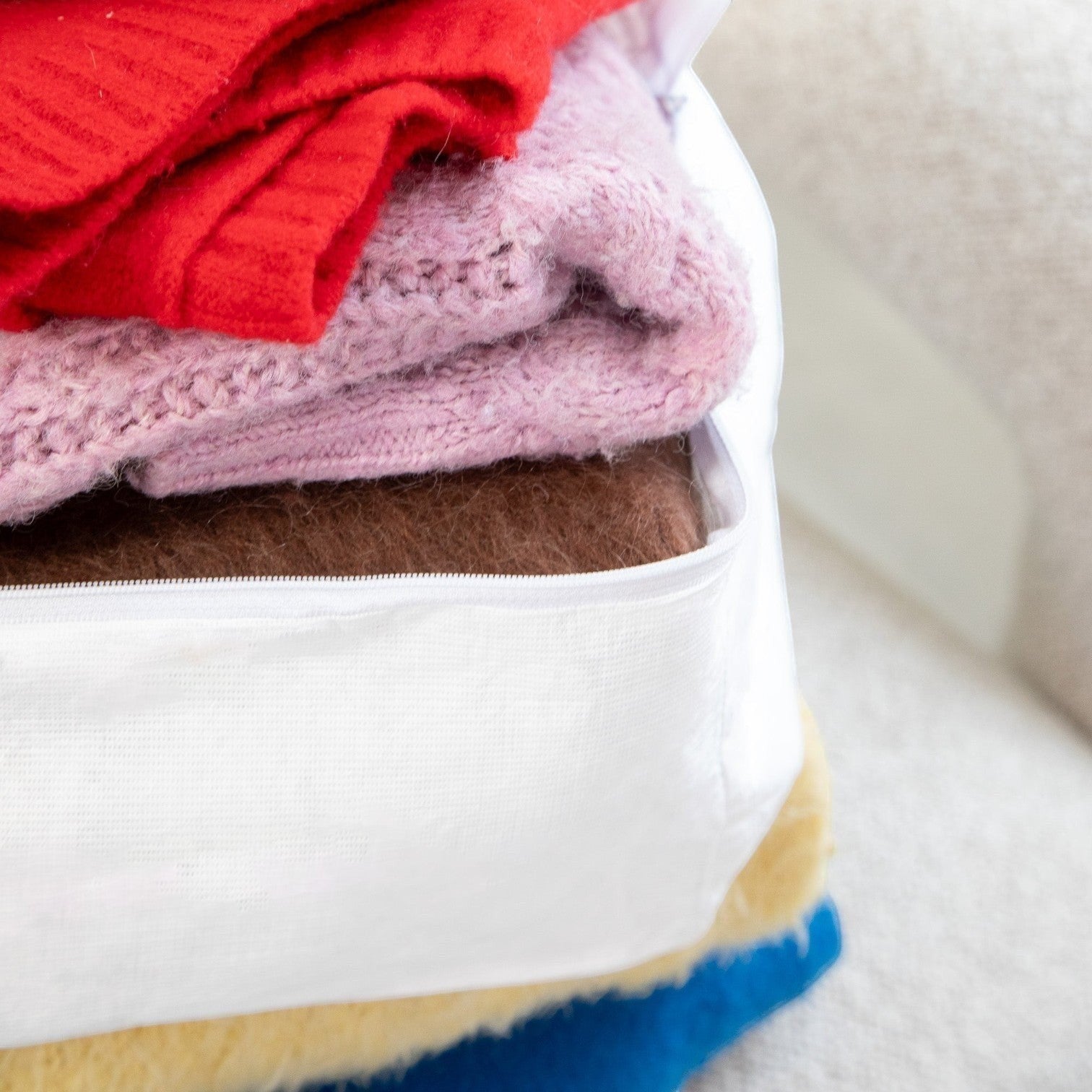 Kept Store small knitwear storage bag in white with a full three-sided zip.