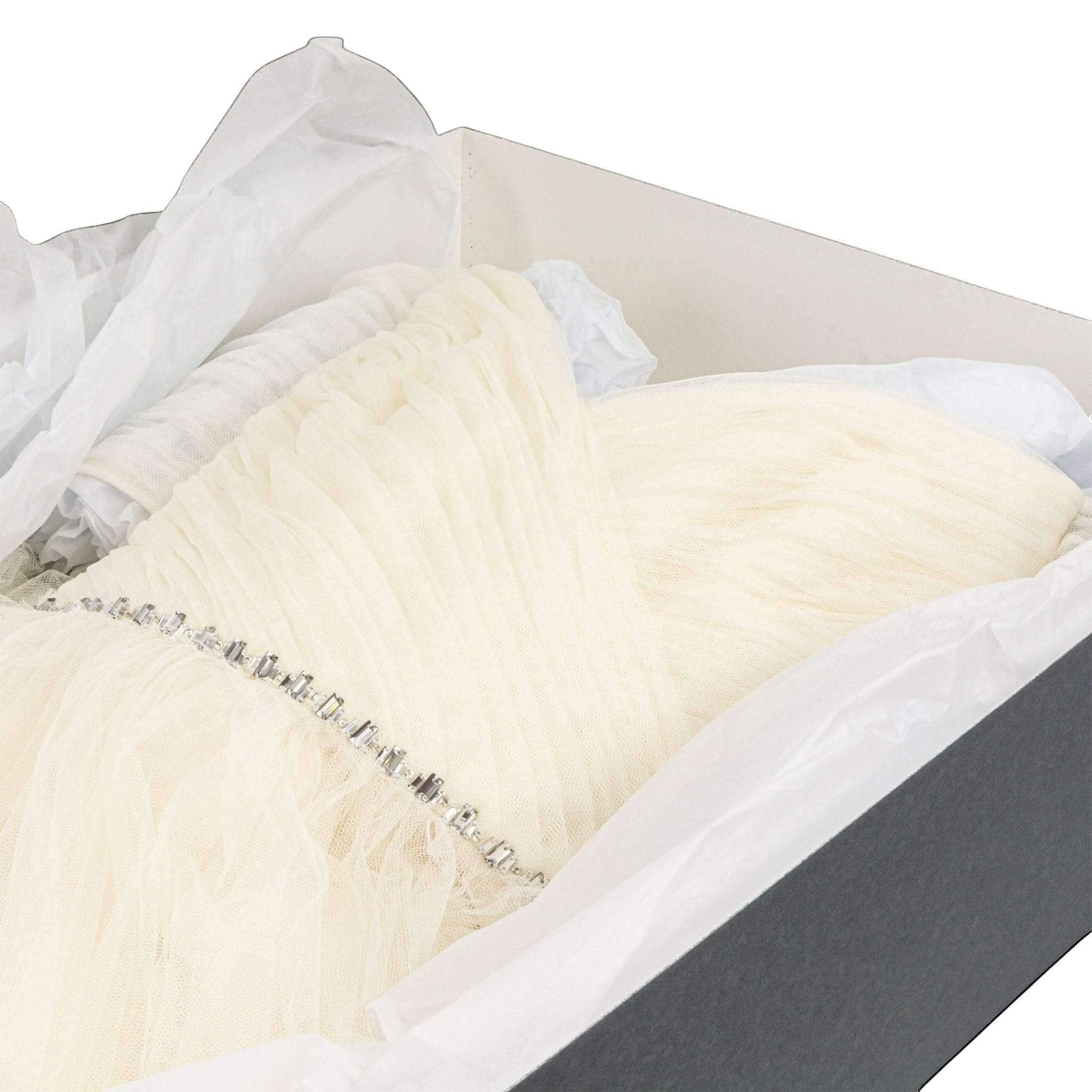 Kept Store acid-free wedding dress storage box with white tissue paper protecting a delicate embellished bridal gown.