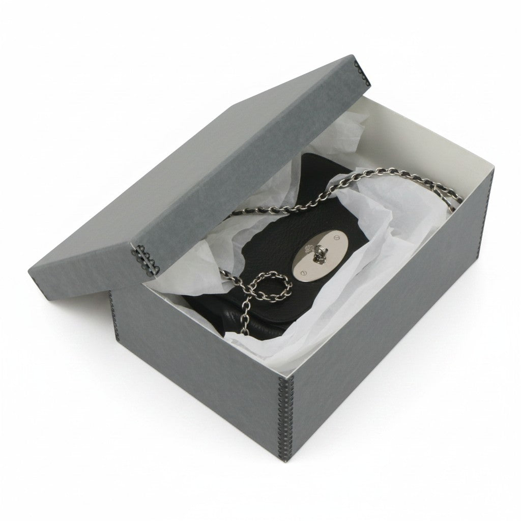 Kept Store acid-free grey storage box protecting a small black leather crossbody handbag with tissue paper.