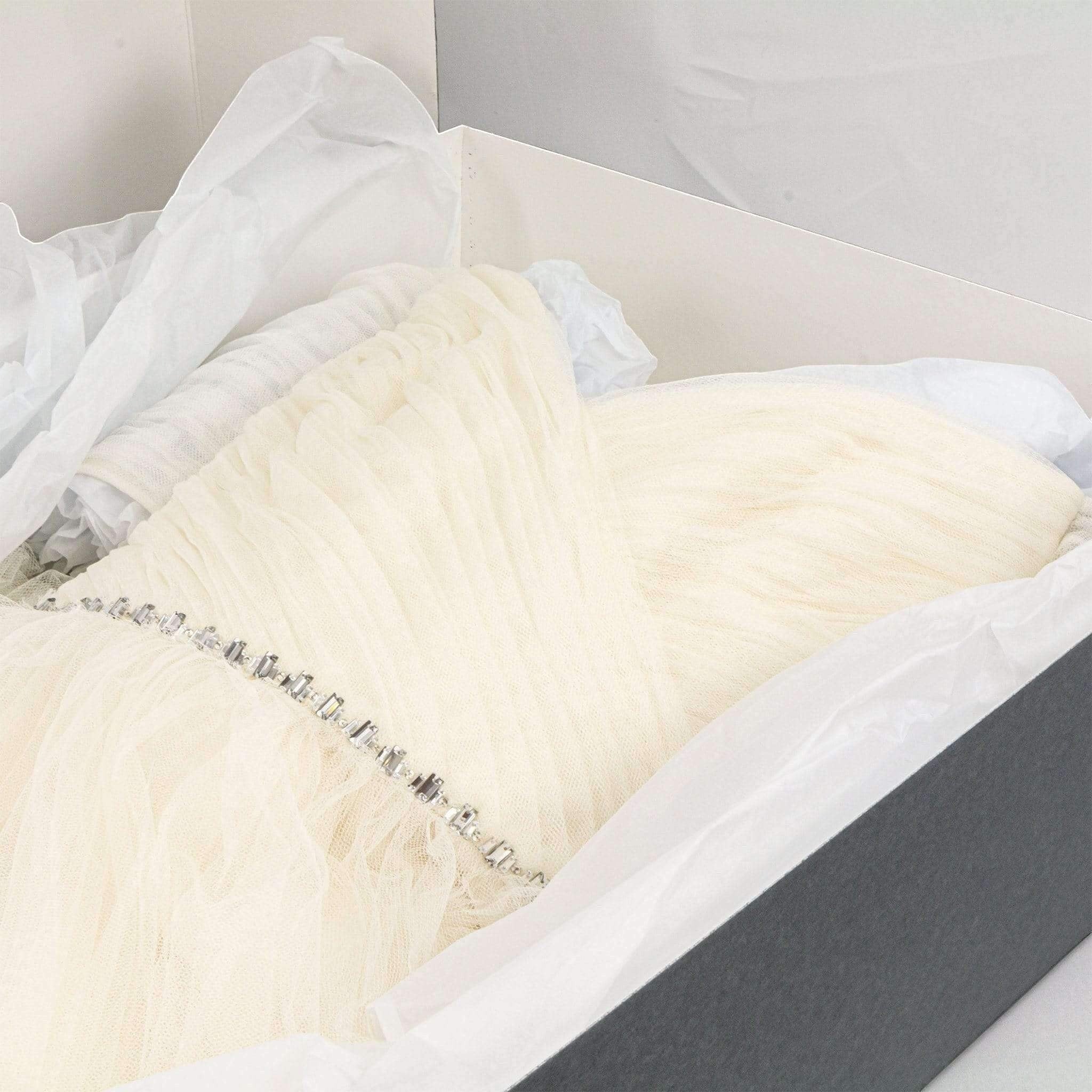 Kept Store acid-free wedding dress storage box with white tissue paper protecting a delicate embellished bridal gown.
