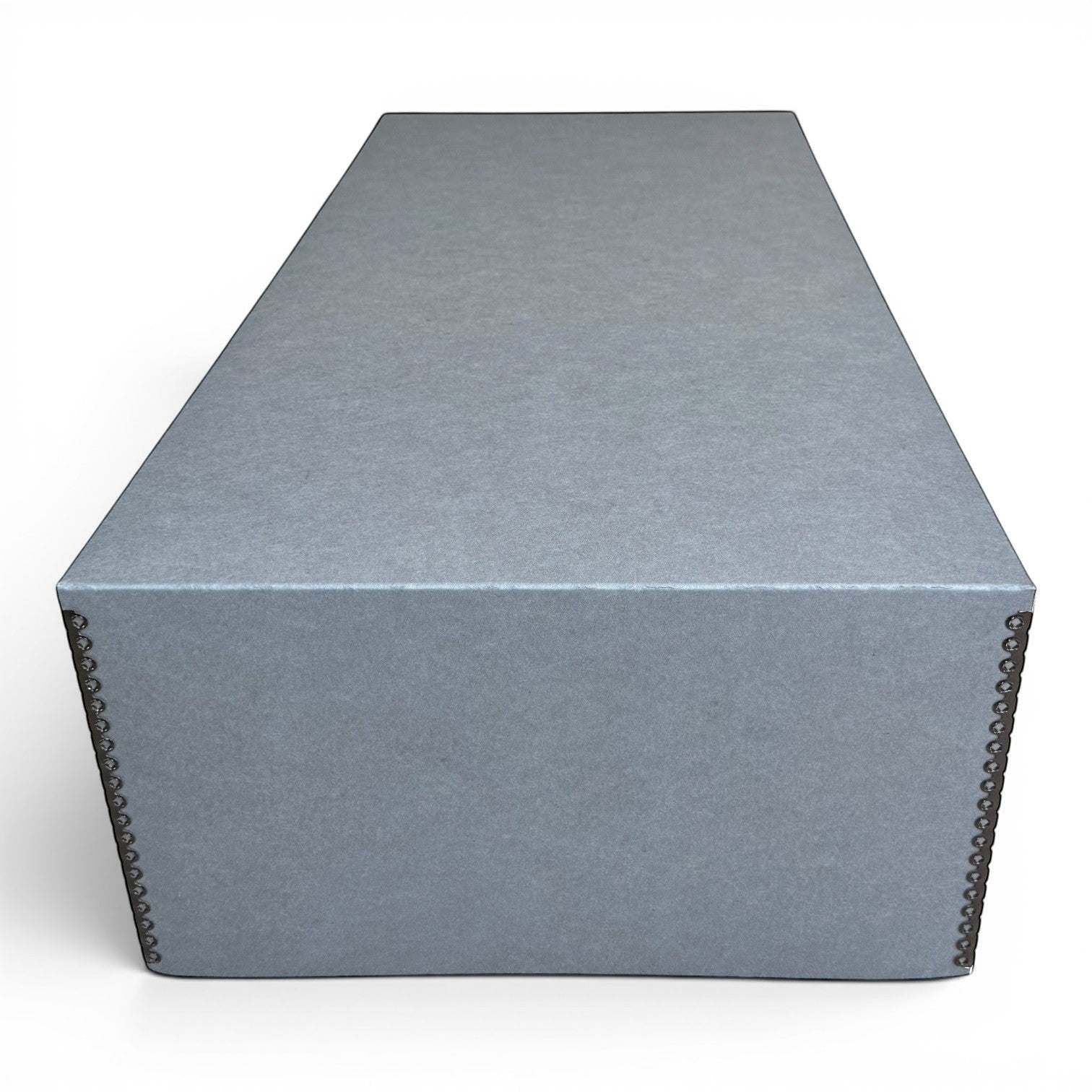 Kept Store extra large acid-free wedding dress storage box in grey with metal rivet detailing on a wooden floor.